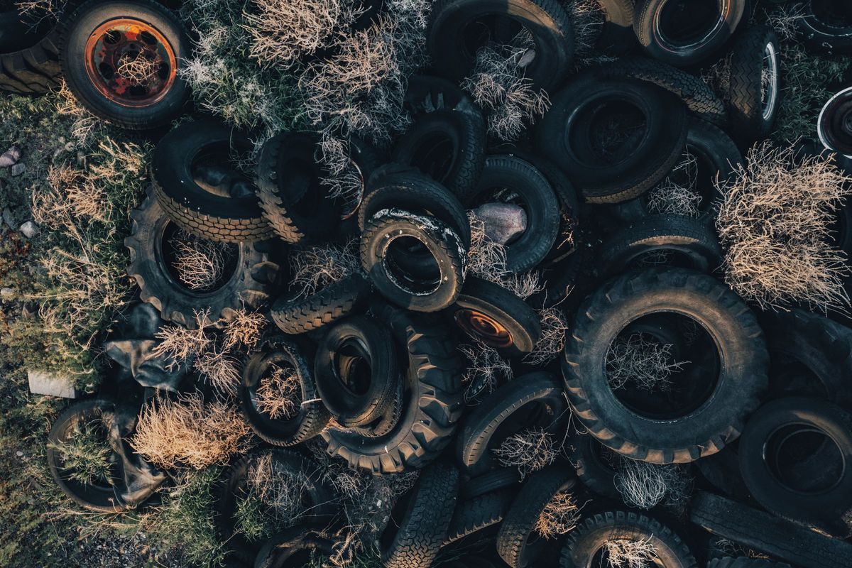 Aerial view of a pile of discarded tires, which are banned from dumpsters in California