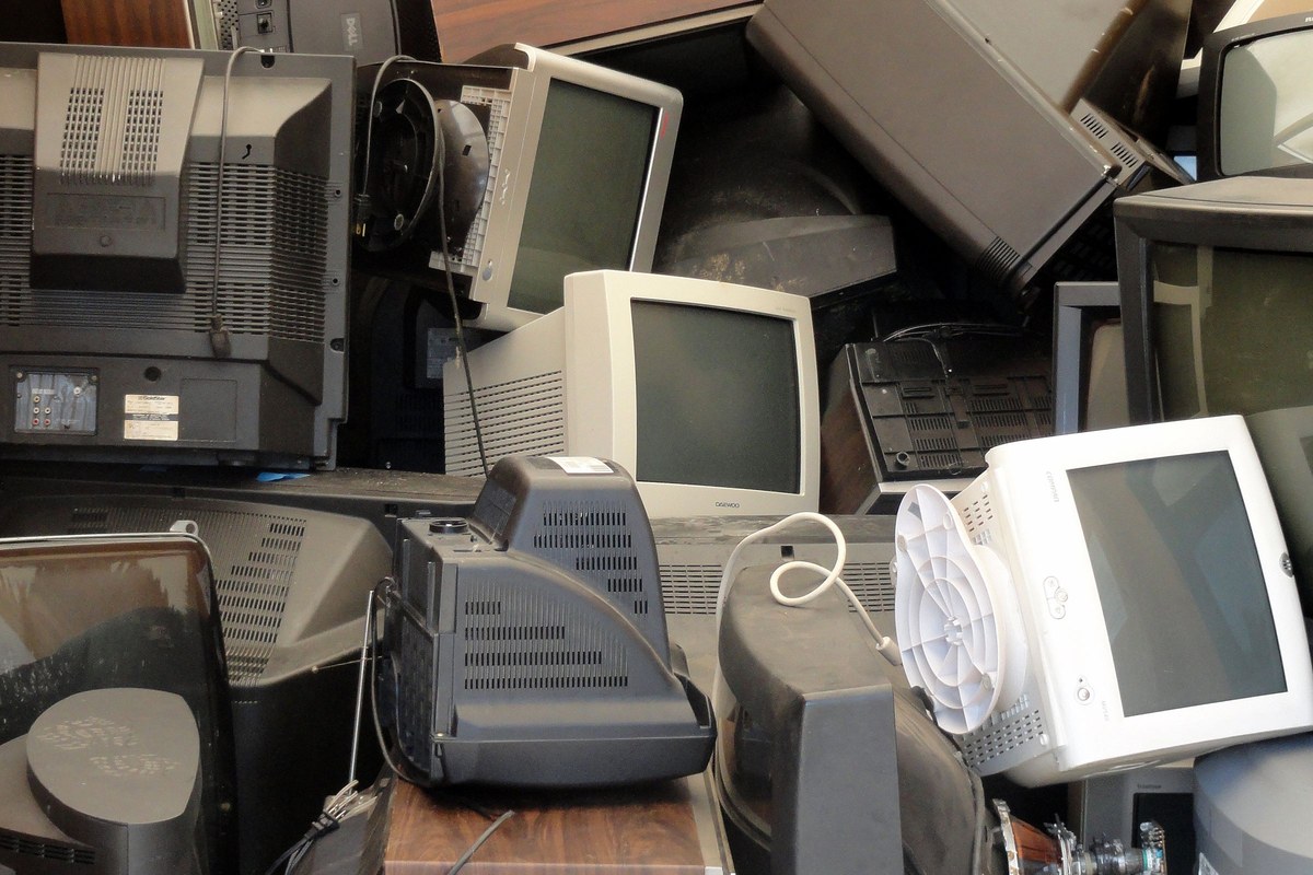 Stack of old televisions and computer monitors collected as e-waste