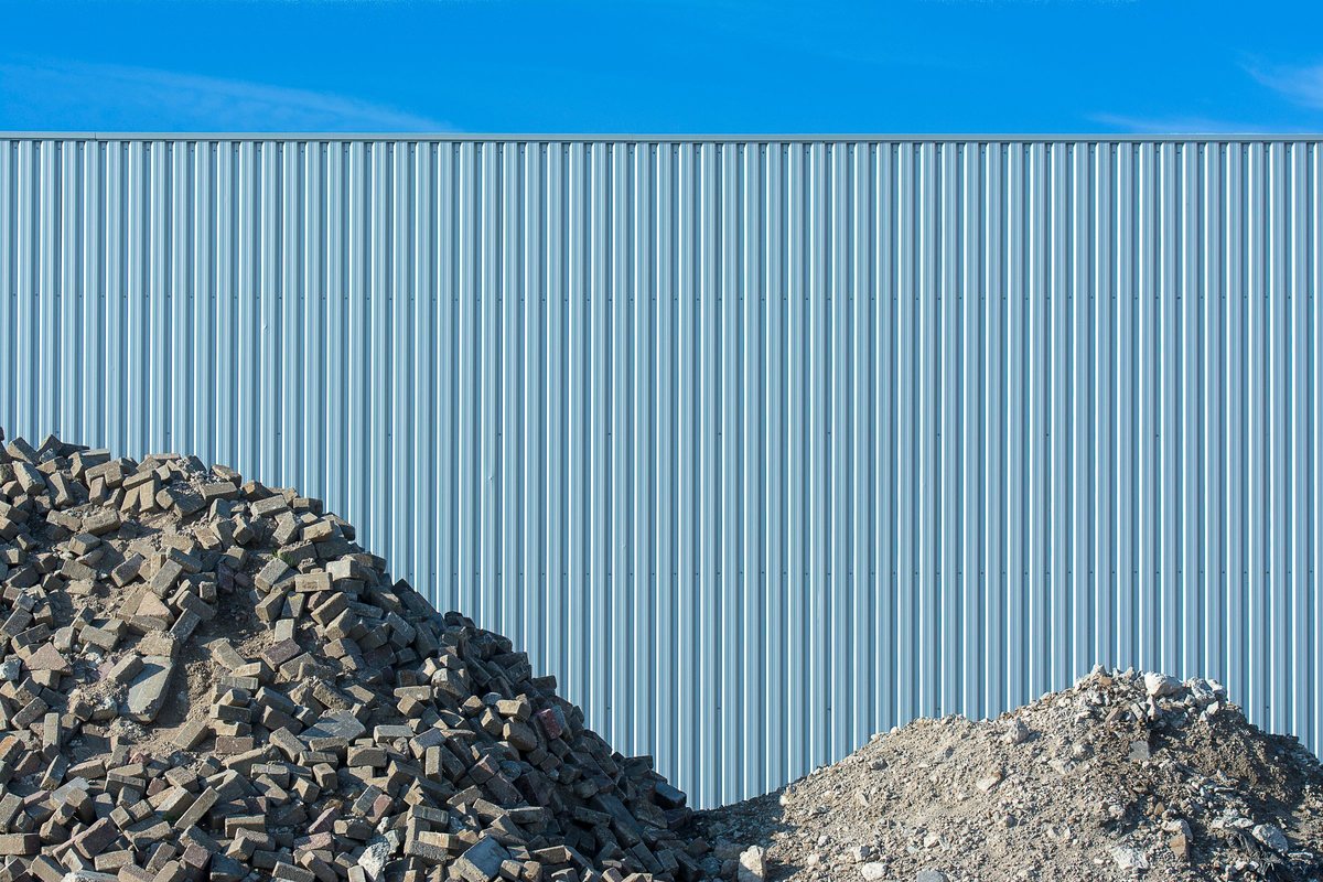 Separated piles of concrete rubble and gravel, sorted to reduce disposal costs