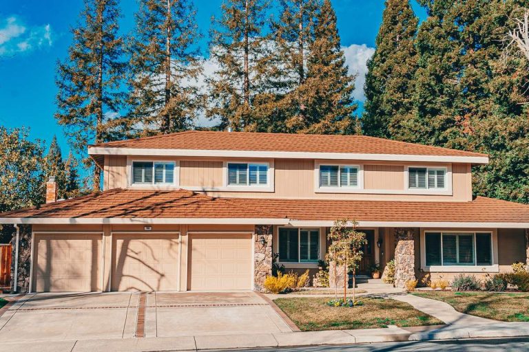 Two-story house with a wide driveway and landscaped front yard